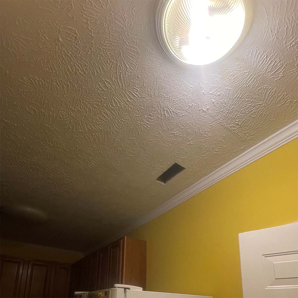 close-up of hand-stomp ceiling texture match around HVAC vent